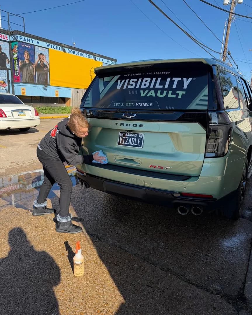 Car detailer applying wax to an SUV at Parker's Detail in Wichita KS