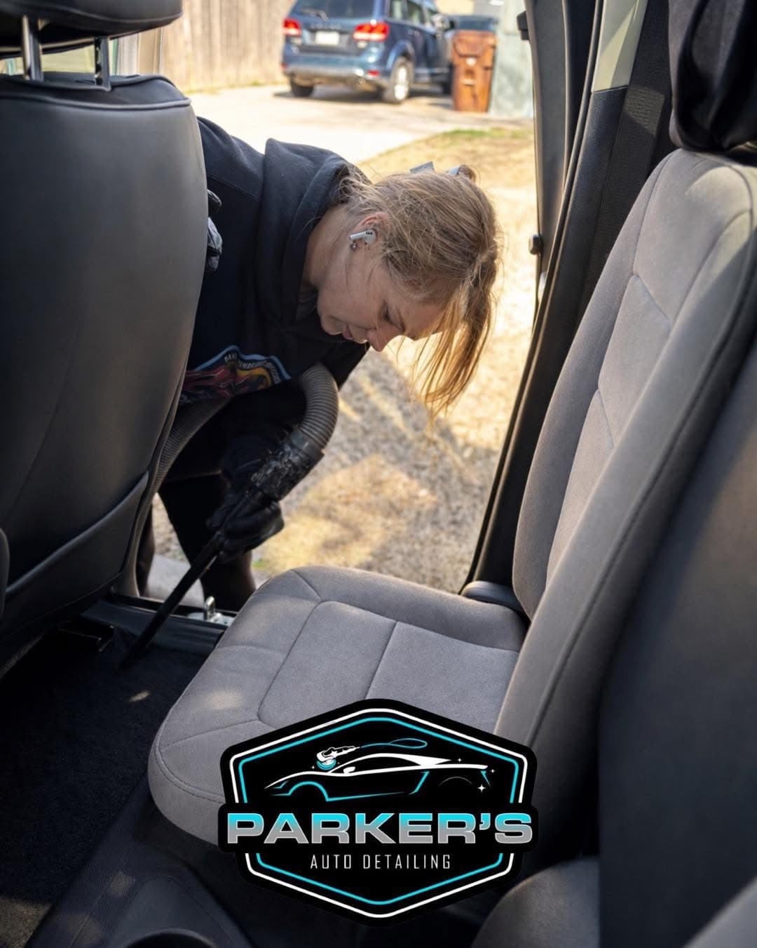 Parker's Detail technician vacuuming interior carpets during a car detailing service in Wichita KS