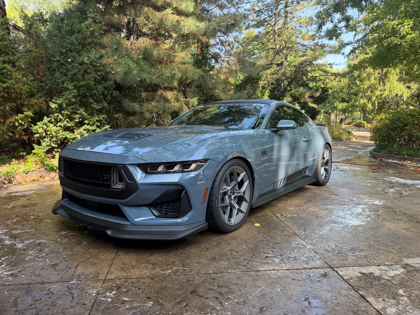 Professional car detailer washing vehicle exterior at Parker's Detail Wichita KS